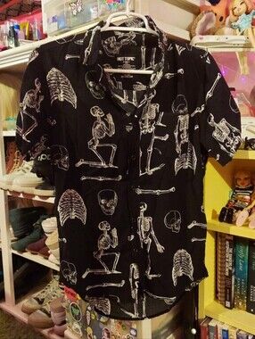 White skeletons on black short sleeve button up collared top
